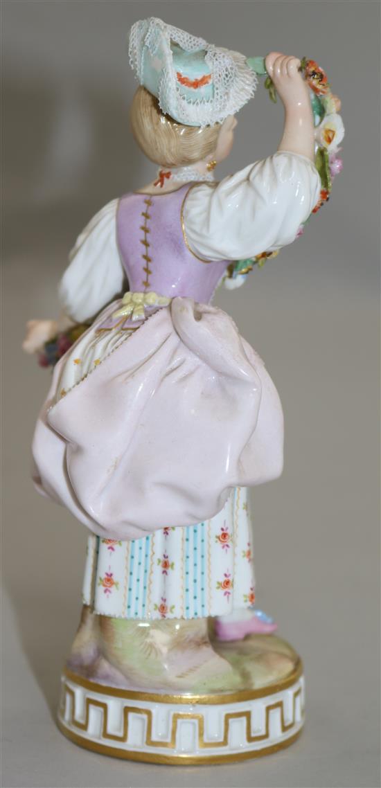 A Meissen figure of a lady holding a garland of flowers, late 19th century, 17cm